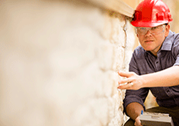 inspecting a foundation repair in JM CONTRACTOR CONSTRUCTION